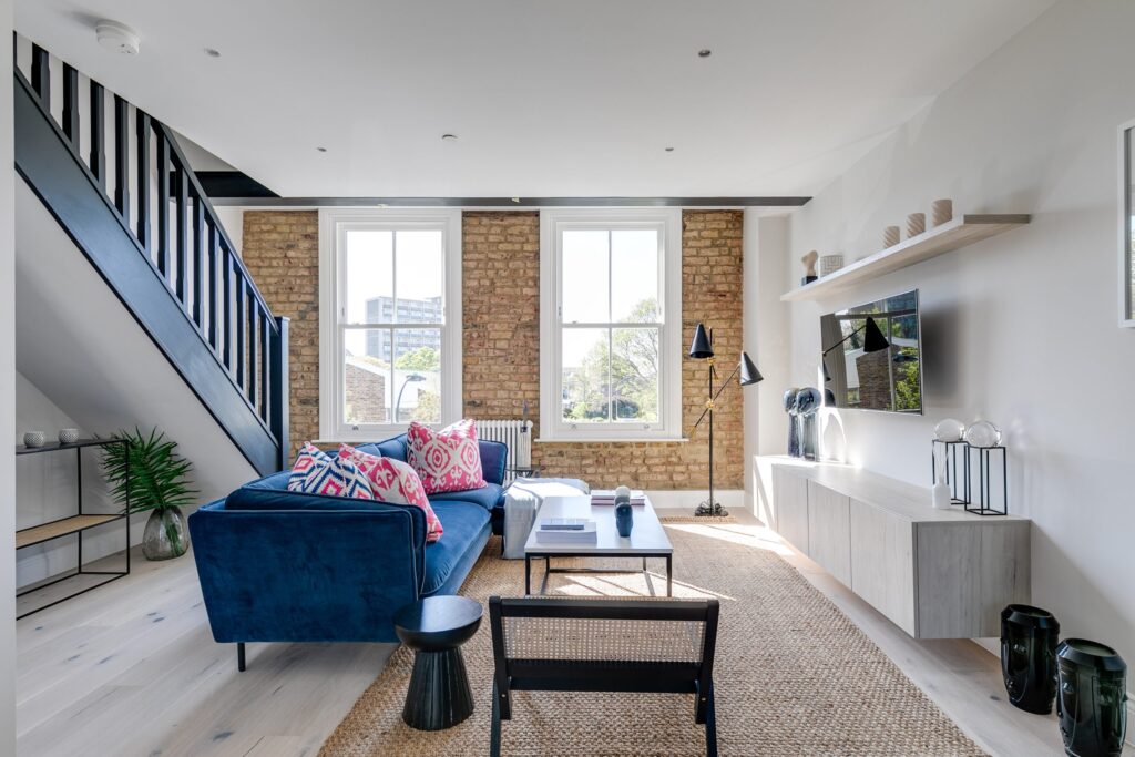 A living room with a blue sofa and a coffee table