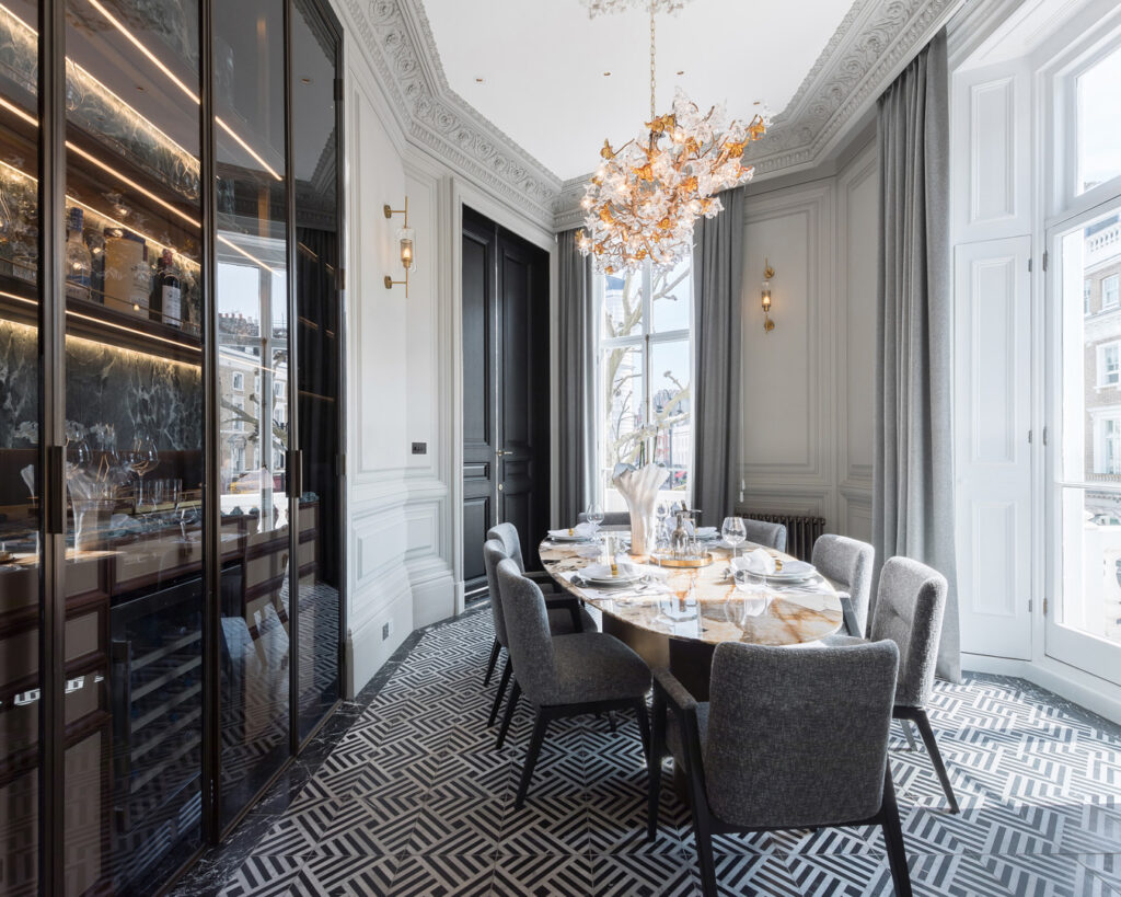 A dining room with a chandelier and a table