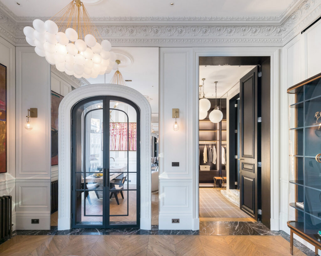 A room with a door and a chandelier