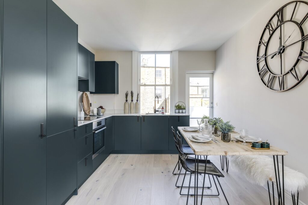 A kitchen with a table and chairs