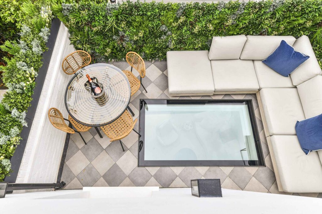 A patio area with a glass table and chairs
