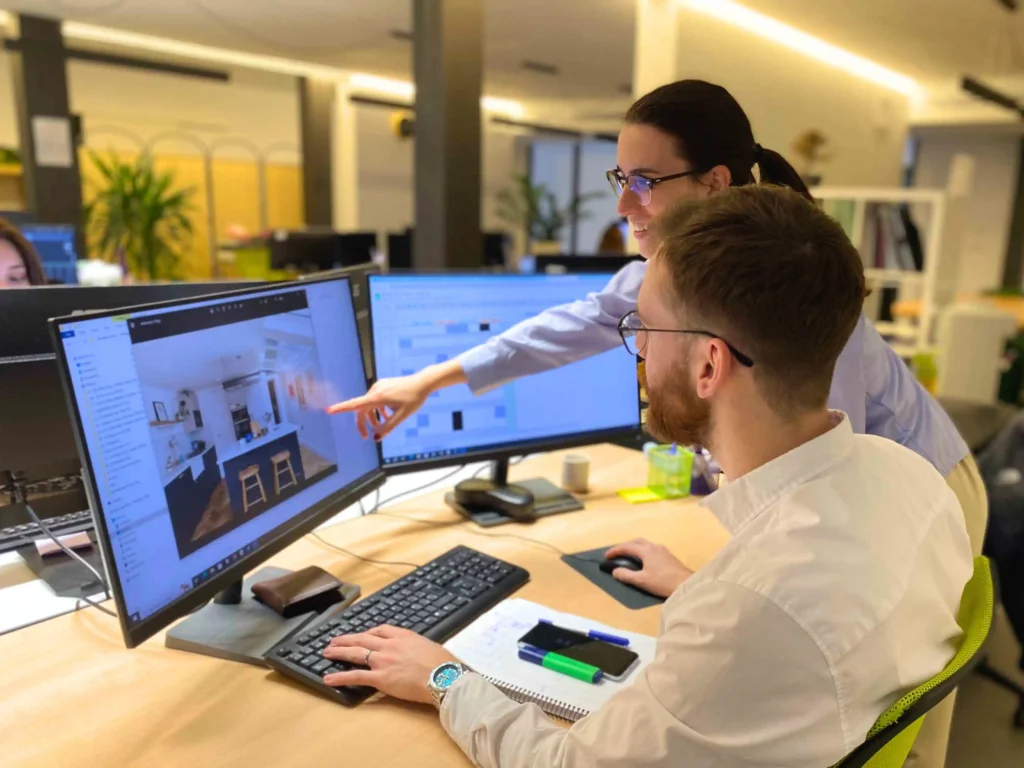 A male and a female architect looking at a computer screen